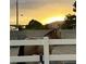 Horse standing in a fenced enclosure at sunset at 7675 Butterscotch Ct, Las Vegas, NV 89131