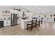 Modern kitchen with stainless steel appliances and a large island and barstool seating at 7675 Butterscotch Ct, Las Vegas, NV 89131