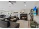 Spacious living room with a fireplace, black leather couches, decor, and access to the backyard at 7675 Butterscotch Ct, Las Vegas, NV 89131