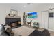 Bright living room boasts a charming fireplace, decor, and mounted flat-screen television at 7675 Butterscotch Ct, Las Vegas, NV 89131