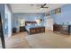 Spacious main bedroom features blue walls, hardwood floors, a ceiling fan, and a closet at 7675 Butterscotch Ct, Las Vegas, NV 89131