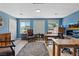 Home office space with hardwood floors, blue walls, a ceiling fan, and a large window at 7675 Butterscotch Ct, Las Vegas, NV 89131