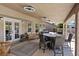 Inviting covered patio with a dining area, comfortable seating, and stylish lighting at 7675 Butterscotch Ct, Las Vegas, NV 89131