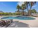 Large pool surrounded by palm trees, a green lawn, and a white fence, perfect for relaxing at 7675 Butterscotch Ct, Las Vegas, NV 89131