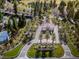 Aerial view of a gated community entrance featuring lush landscaping and mature trees at 7889 Rancho Mirage Dr, Las Vegas, NV 89113