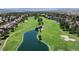 Aerial view of community featuring lush golf course, pond, mature trees and upscale homes at 7889 Rancho Mirage Dr, Las Vegas, NV 89113