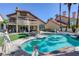 Residential home with spacious backyard pool area, well-manicured turf, and mature palm trees at 7889 Rancho Mirage Dr, Las Vegas, NV 89113