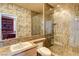 Bathroom with decorative wallpaper, a glass shower, and a granite countertop at 7889 Rancho Mirage Dr, Las Vegas, NV 89113