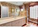 Bright bathroom featuring classic wallpaper, a large mirror, and ample counter space with storage drawers at 7889 Rancho Mirage Dr, Las Vegas, NV 89113