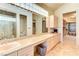 Large bathroom with marble countertops, unique mirror design and views of a walk in closet at 7889 Rancho Mirage Dr, Las Vegas, NV 89113
