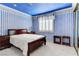 Charming bedroom with blue wallpaper, moon and stars ceiling and plush carpet at 7889 Rancho Mirage Dr, Las Vegas, NV 89113