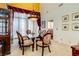 Formal dining room featuring a glass table, decorative chairs, and elegant lighting at 7889 Rancho Mirage Dr, Las Vegas, NV 89113