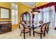 Elegant dining room with a glass-topped table, patterned chairs, and built-in display cabinet at 7889 Rancho Mirage Dr, Las Vegas, NV 89113