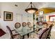 Formal dining area with a modern glass table and upholstered chairs at 7889 Rancho Mirage Dr, Las Vegas, NV 89113