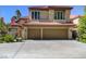Two-story home with terracotta tile roof and a spacious two-car garage on a sunny day at 7889 Rancho Mirage Dr, Las Vegas, NV 89113