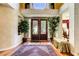 Elegant foyer with hardwood floors, a decorative rug, and a view into the formal dining room at 7889 Rancho Mirage Dr, Las Vegas, NV 89113