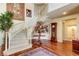 Stately foyer with a curved staircase, hardwood floors, and an elegant grandfather clock at 7889 Rancho Mirage Dr, Las Vegas, NV 89113