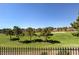Scenic view of a golf course featuring lush green fairways, mature trees, and luxury homes at 7889 Rancho Mirage Dr, Las Vegas, NV 89113
