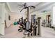 Bright home gym with mirrored wall, ceiling fan, wall storage and a variety of equipment at 7889 Rancho Mirage Dr, Las Vegas, NV 89113