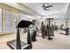 Well-lit home gym featuring mirrored walls, carpeted flooring, and a variety of exercise equipment at 7889 Rancho Mirage Dr, Las Vegas, NV 89113