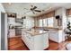 Spacious kitchen featuring wooden floors, an island, stainless appliances and plenty of natural light at 7889 Rancho Mirage Dr, Las Vegas, NV 89113
