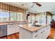 Kitchen features an island, stainless dishwasher, breakfast bar, and lots of natural light at 7889 Rancho Mirage Dr, Las Vegas, NV 89113