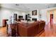Cozy living room with a fireplace, wood floors, and comfortable seating at 7889 Rancho Mirage Dr, Las Vegas, NV 89113