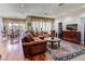 Spacious living room featuring wood floors and a comfortable leather couch with decorative pillows at 7889 Rancho Mirage Dr, Las Vegas, NV 89113