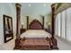 Elegant main bedroom with a large four-poster bed, bench, and neutral color palette at 7889 Rancho Mirage Dr, Las Vegas, NV 89113