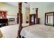 Spacious main bedroom showcasing a fireplace, built-in shelves, and a cozy seating area at 7889 Rancho Mirage Dr, Las Vegas, NV 89113