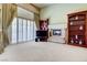 Comfortable main bedroom with fireplace, plantation shutters, and custom built-in bookcases at 7889 Rancho Mirage Dr, Las Vegas, NV 89113