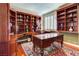 Elegant office with custom wood bookshelves, a large desk, and an oriental rug at 7889 Rancho Mirage Dr, Las Vegas, NV 89113