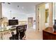 Functional office space with a glass desk and a view of the living area at 7889 Rancho Mirage Dr, Las Vegas, NV 89113