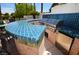 A great outdoor kitchen area with custom bar and stainless steel grill, perfect for entertaining at 7889 Rancho Mirage Dr, Las Vegas, NV 89113