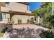 Enclosed outdoor patio with stone pavers, a decorative bench, and mature landscaping at 7889 Rancho Mirage Dr, Las Vegas, NV 89113