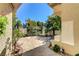 Private outdoor patio featuring stone pavers, a bench, and mature landscaping at 7889 Rancho Mirage Dr, Las Vegas, NV 89113