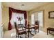 Serene sitting room with comfortable chairs, a decorative table, and elegant window treatments at 7889 Rancho Mirage Dr, Las Vegas, NV 89113