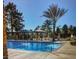 Inviting swimming pool with shaded seating, surrounded by palm trees, perfect for cooling off at 7889 Rancho Mirage Dr, Las Vegas, NV 89113