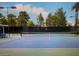 Well-maintained tennis court with net, surrounded by trees, perfect for recreational play at 7889 Rancho Mirage Dr, Las Vegas, NV 89113