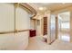 Spacious walk-in closet with custom shelving, drawers, and ornate design with access to bathroom at 7889 Rancho Mirage Dr, Las Vegas, NV 89113