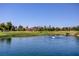 Scenic water view overlooking the golf course with well-manicured greens and beautiful homes in the background at 7889 Rancho Mirage Dr, Las Vegas, NV 89113