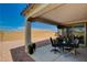 Inviting covered patio features stylish furniture and decor, offering a cozy outdoor living space with beautiful views at 8286 Skye Gorge St, Las Vegas, NV 89166