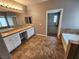 Large bathroom featuring double sinks, bathtub, and doorway at 9052 Pine Mission Ave, Las Vegas, NV 89143