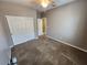 Bedroom with a ceiling fan, carpeted floor, large window, and closet with sliding doors at 9052 Pine Mission Ave, Las Vegas, NV 89143
