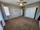 Spacious bedroom with a ceiling fan, carpeted floor, large window, and closet with sliding doors at 9052 Pine Mission Ave, Las Vegas, NV 89143
