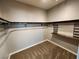 Walk-in closet with custom shelving and carpeted floor at 9052 Pine Mission Ave, Las Vegas, NV 89143