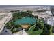 Scenic aerial shot of a community lake surrounded by lush trees and well-maintained green spaces at 9052 Pine Mission Ave, Las Vegas, NV 89143