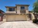 Two-story home featuring a three-car garage, stucco exterior, covered entryway, and decorative balcony in a residential neighborhood at 9052 Pine Mission Ave, Las Vegas, NV 89143