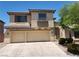 Two story home with a three car garage, desert landscaping, and neutral color palette at 9052 Pine Mission Ave, Las Vegas, NV 89143