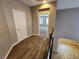 Second story hallway with view to carpeted bedroom and staircase at 9052 Pine Mission Ave, Las Vegas, NV 89143